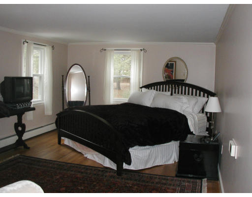 17 Round Hill Road Weston, MA 02493 - Photo 4 of 17 a bedroom with a bed a mirror and a window