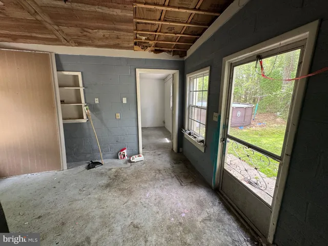 a view of a lake with a table and chairs under an umbrella