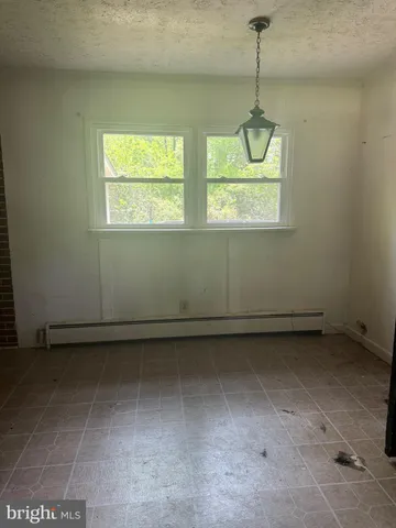 a kitchen with stainless steel appliances a sink a stove top oven a counter space and cabinets