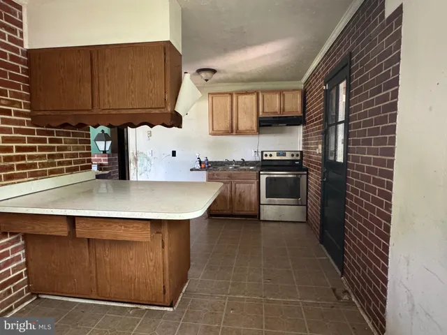 a kitchen with granite countertop a stove and a sink