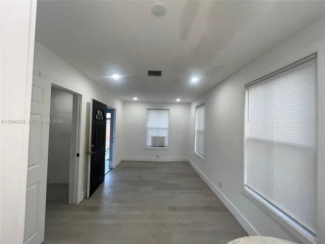 an empty room with closet and wooden floor