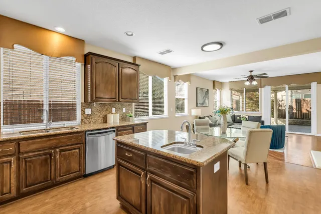 a view of a big room with wooden floor and windows
