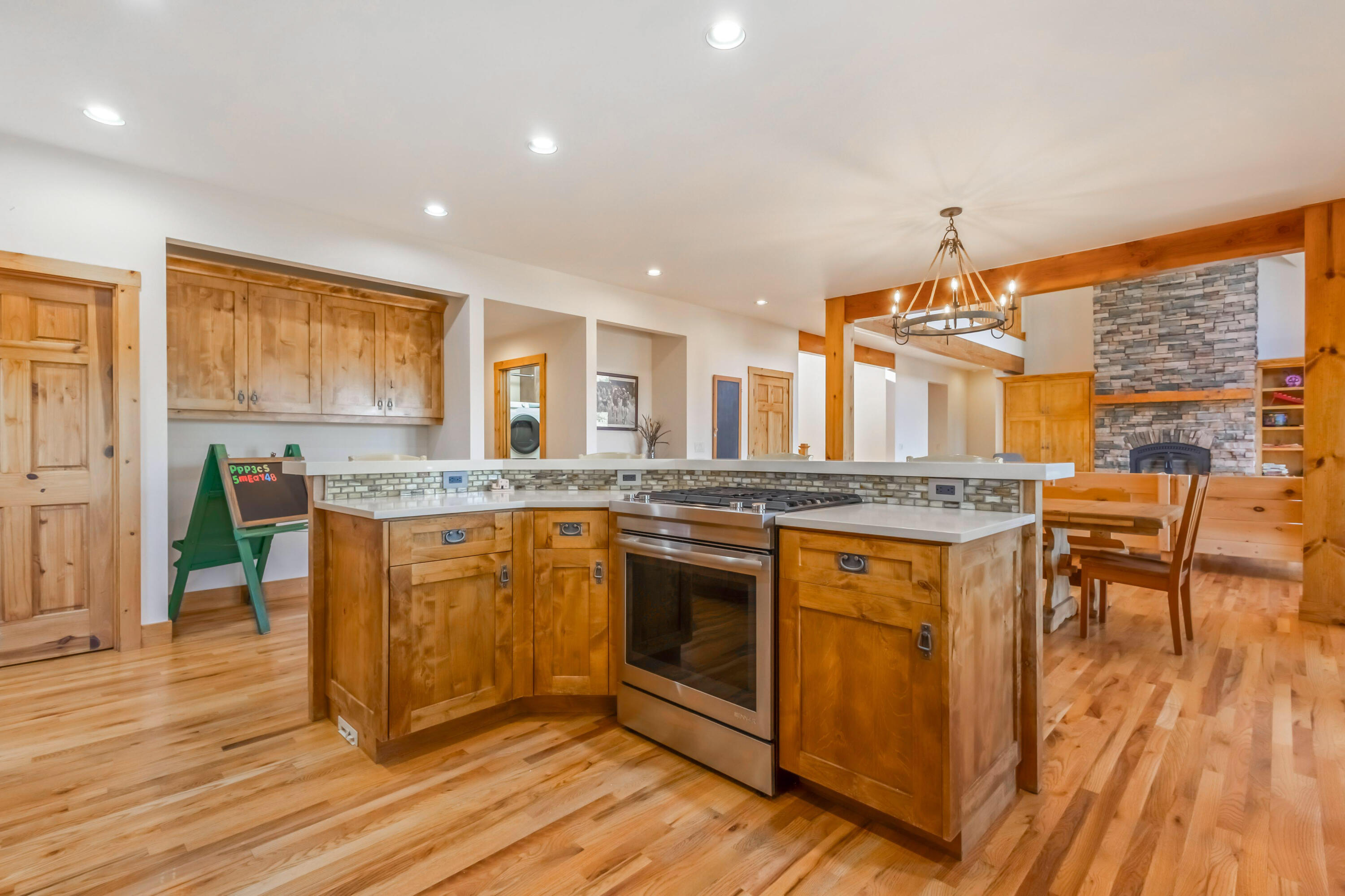 69590 Omaha Road Sisters, OR 97759 - Photo 16 of 46 a kitchen with stainless steel appliances granite countertop a stove and a wooden floors