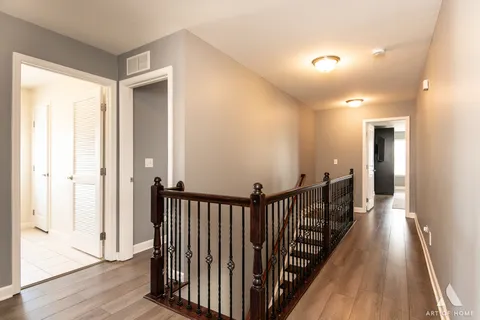a spacious bedroom with a bed and a flat screen tv