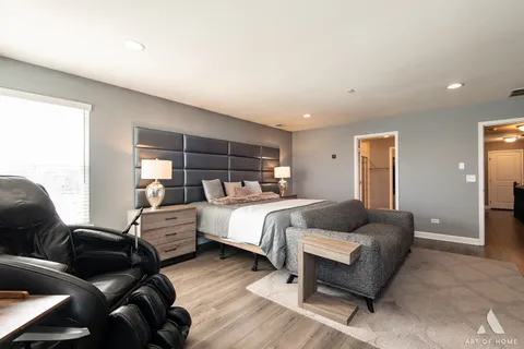 a bedroom with a bed wooden floor and window