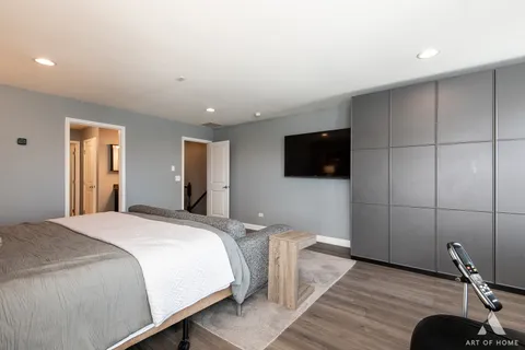 a bedroom with a bed and a flat screen tv