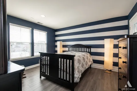 a bedroom with a bed and a night stand