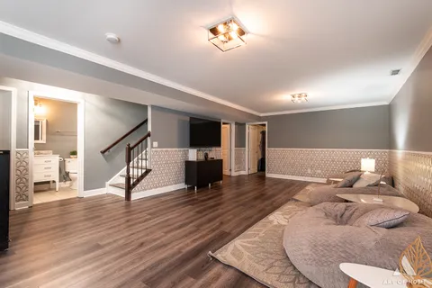 a house view with large trees in front of it