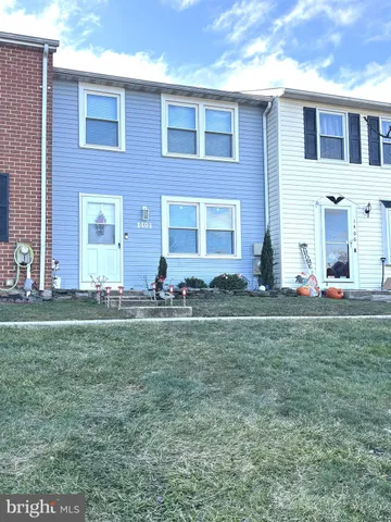 a front view of house with yard and outdoor seating