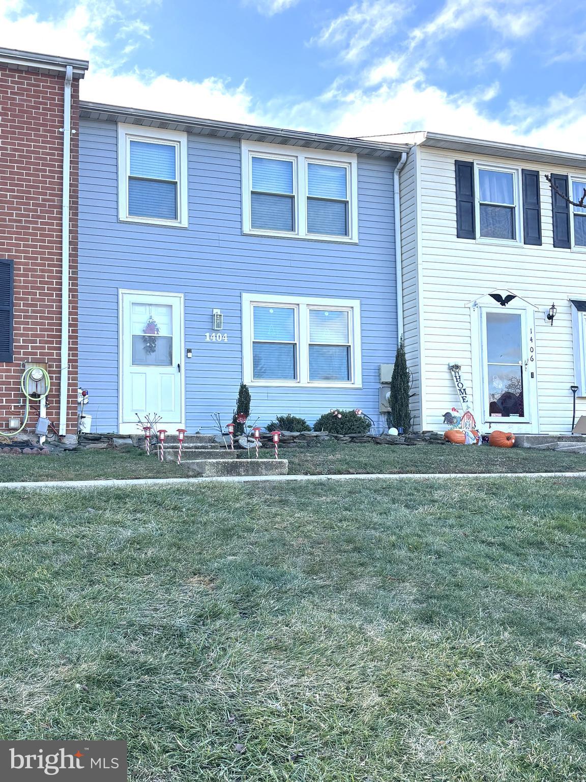 a front view of house with yard and outdoor seating