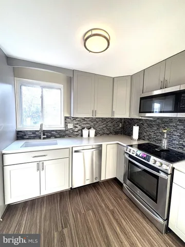 a kitchen with granite countertop a stove and a sink