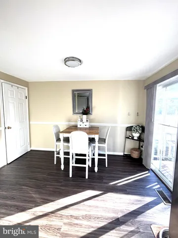 a view of a dining room with furniture wooden floor and a window