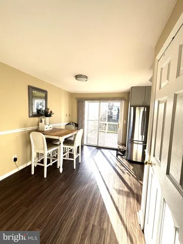 a dining room with furniture and wooden floor