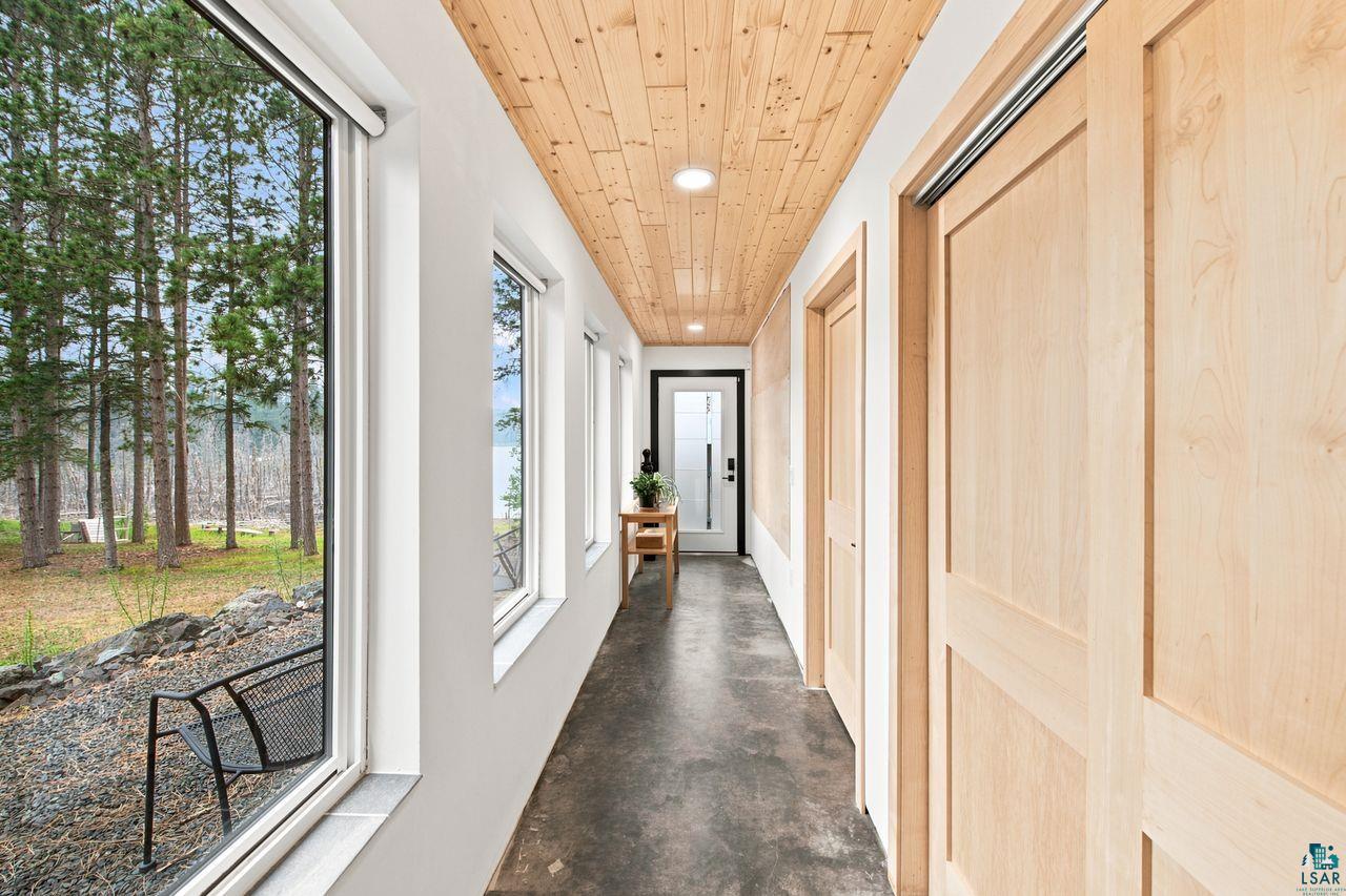 5400 Eightmile Lake Road Iron River, WI 54847 - Photo 13 of 37 Hallway with a wood-finish plank ceiling, recessed lighting, and multiple windows