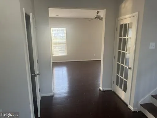 an empty room with wooden floor and a window
