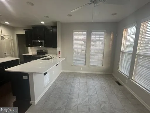 a kitchen with a sink a stove a refrigerator and a cabinets