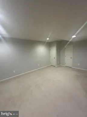 a bathroom with a granite countertop toilet and a sink