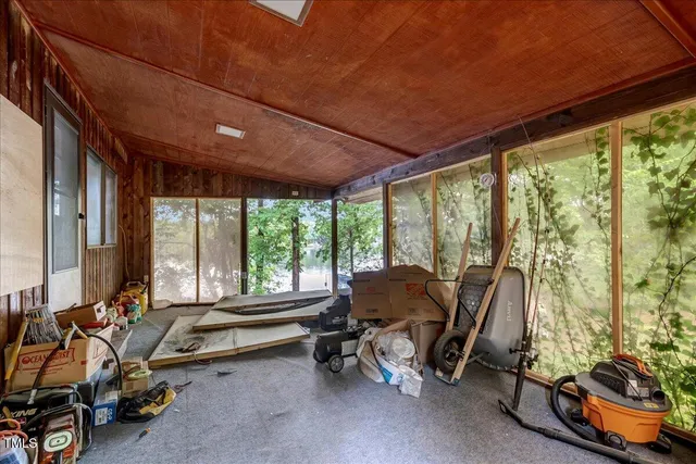 an aerial view of a house with a yard and a lake view
