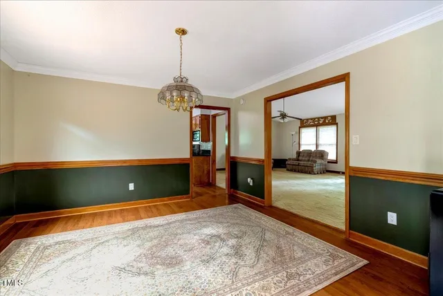 a kitchen with granite countertop a sink window and cabinets