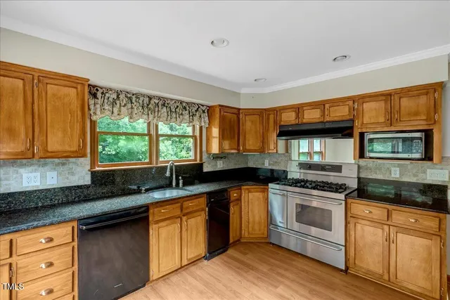 a view of hallway with a door and a bathroom