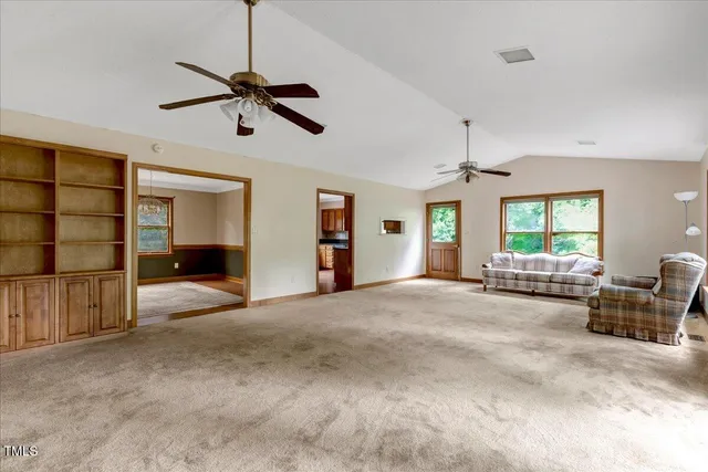 a view of a livingroom with a ceiling fan and window