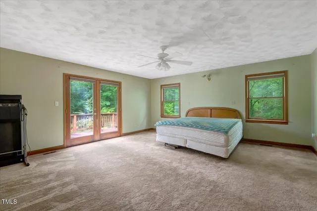 a bathroom with a granite countertop toilet a sink and a mirror