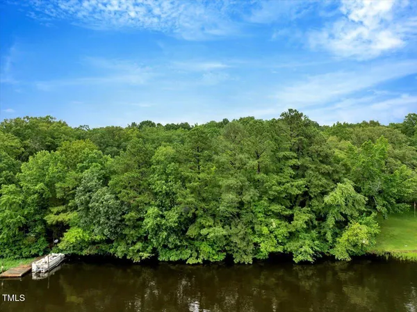 a view of a lake with a house in the background
