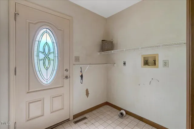 a backyard of a house with table and chairs