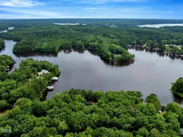 an aerial view of a houses with ocean view