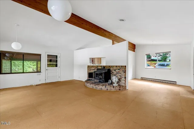 a view of a livingroom with furniture and a fireplace