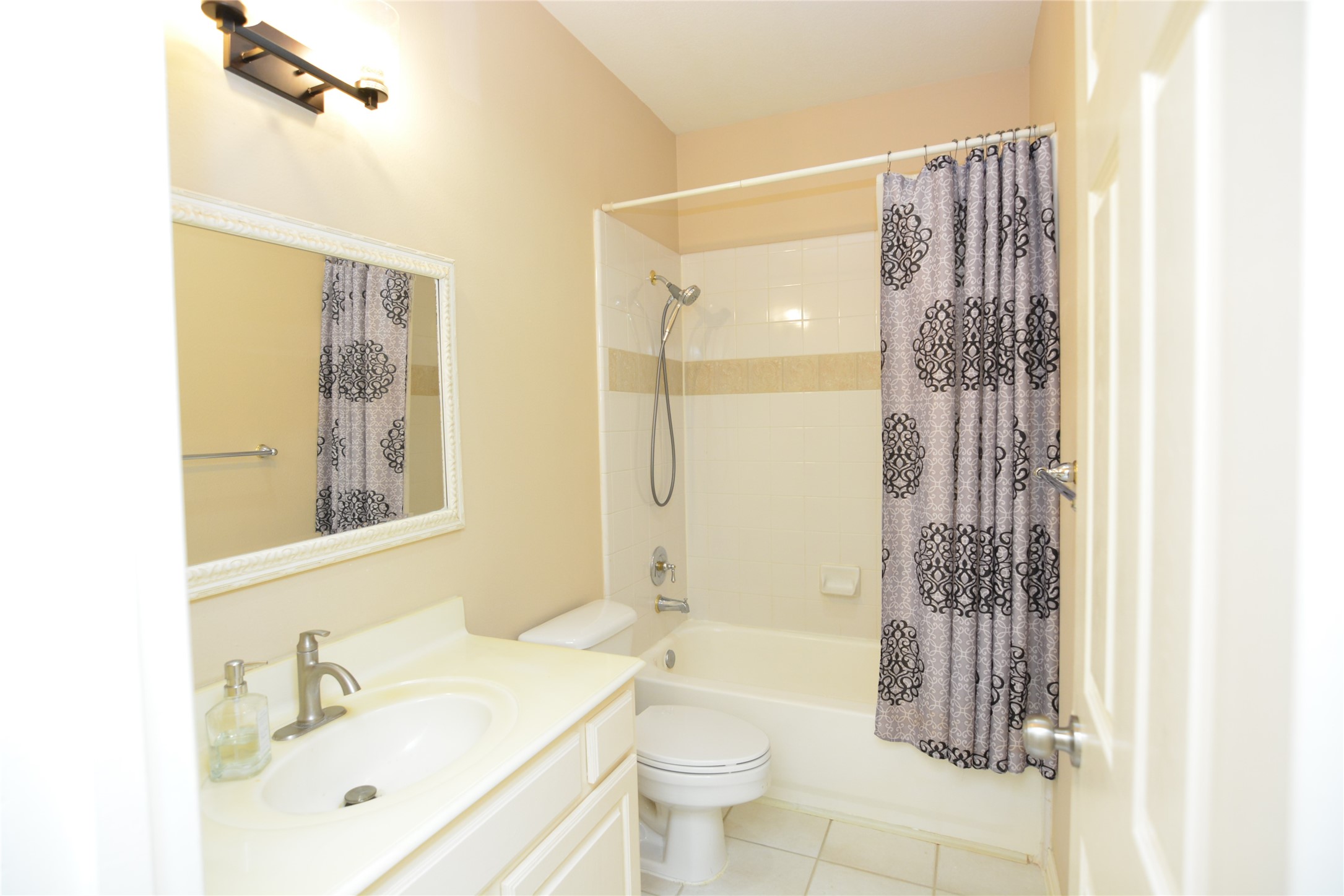 6119 Windwater Pointe Houston, TX 77036 - Photo 14 of 23 a bathroom with a shower a sink and a mirror