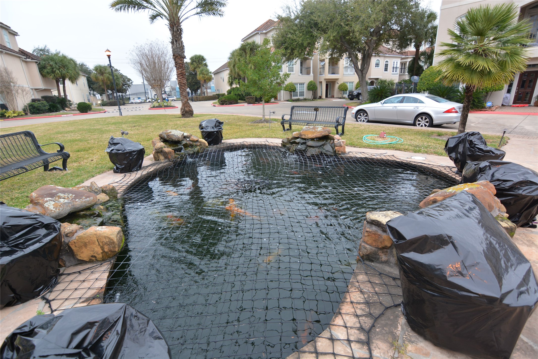 6119 Windwater Pointe Houston, TX 77036 - Photo 21 of 23 a view of a swimming pool with lawn chairs and couches chairs