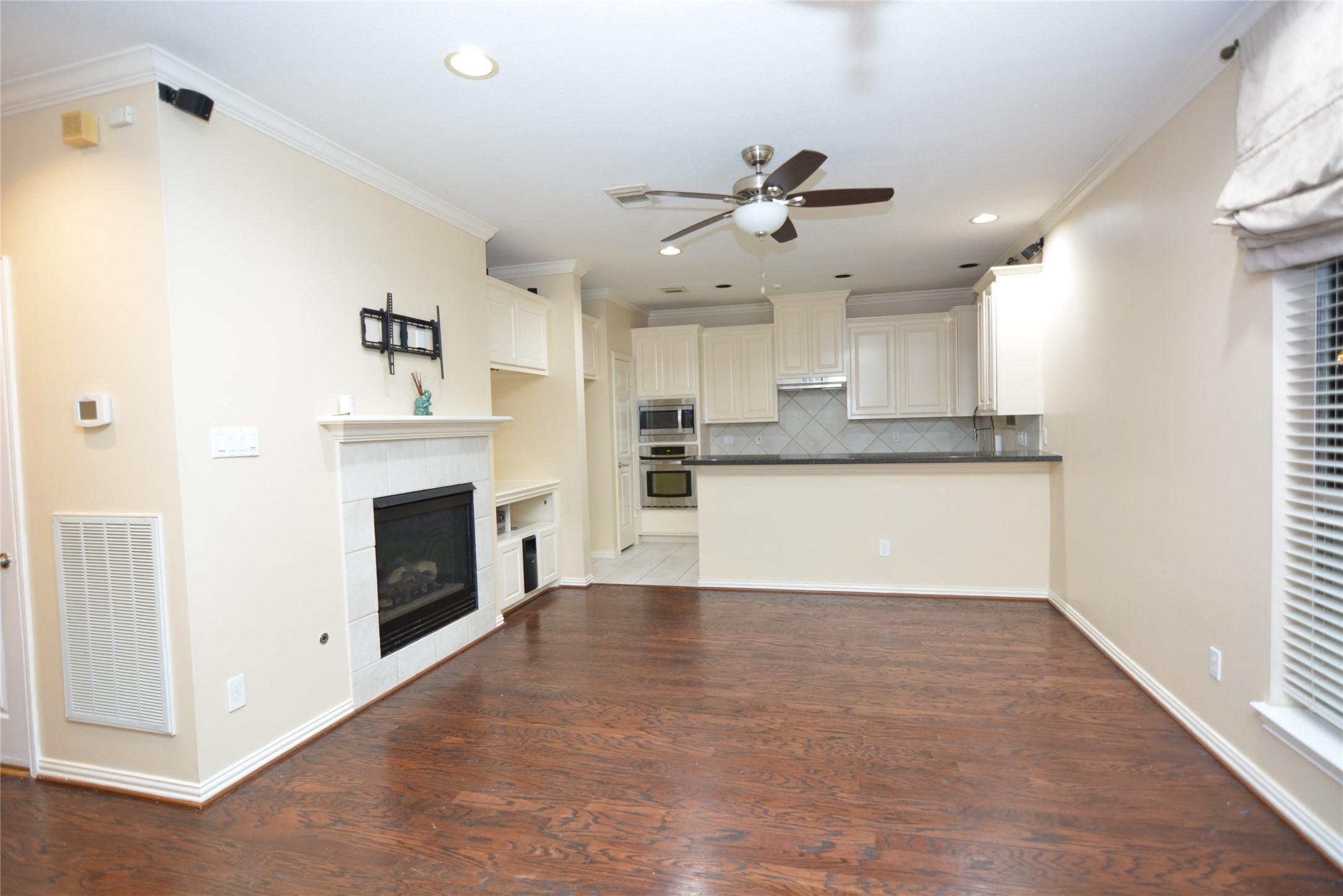 6119 Windwater Pointe Houston, TX 77036 - Photo 3 of 23 a view of a kitchen with a sink a fireplace and window