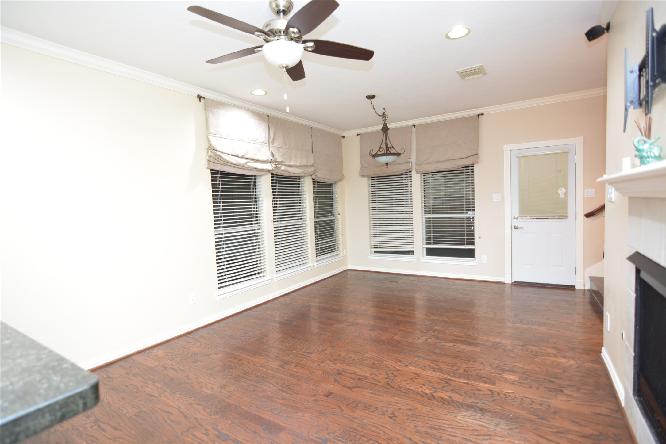 6119 Windwater Pointe Houston, TX 77036 - Photo 5 of 23 a view of an empty room with a window and wooden floor