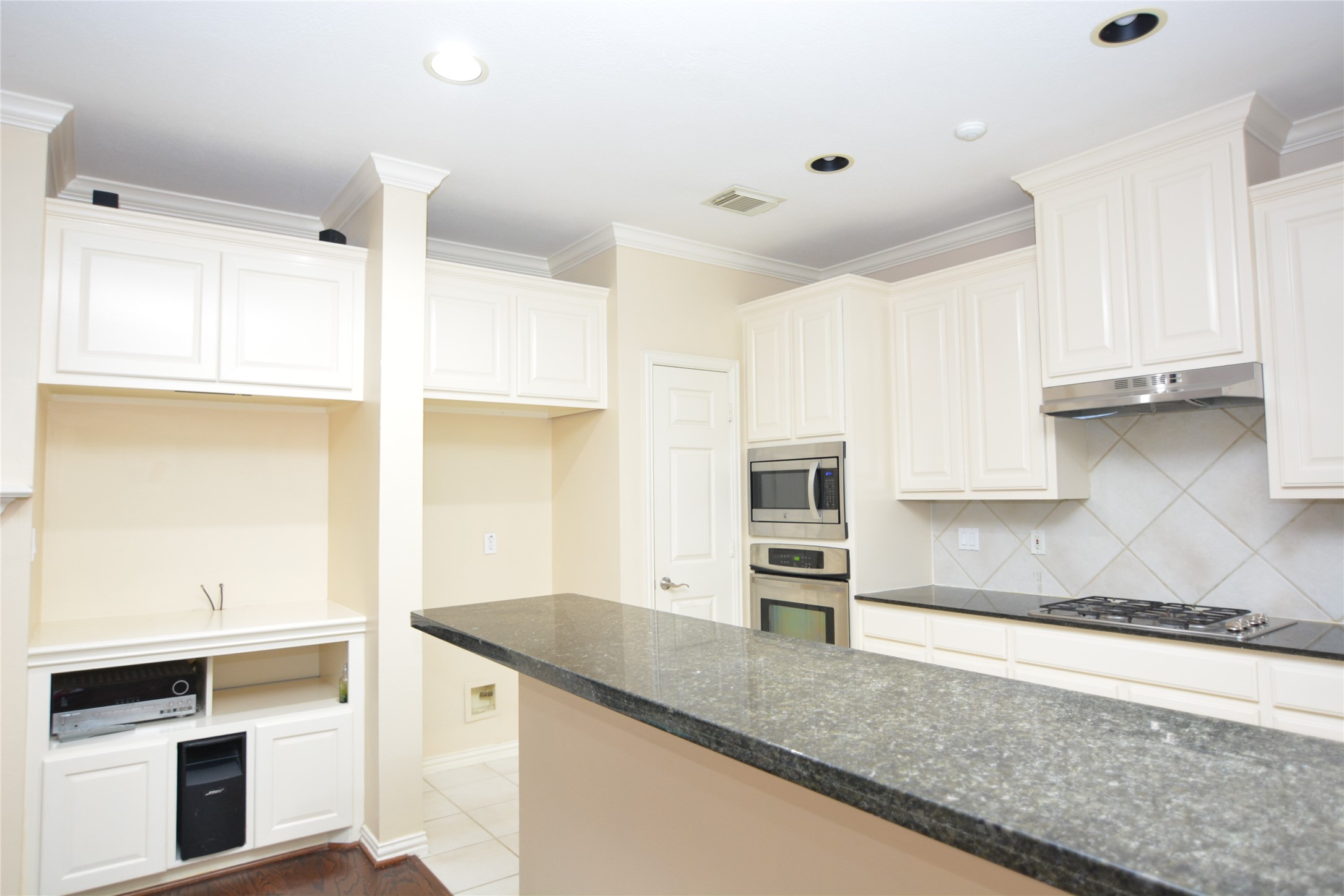 6119 Windwater Pointe Houston, TX 77036 - Photo 7 of 23 a kitchen with stainless steel appliances granite countertop a sink and a stove