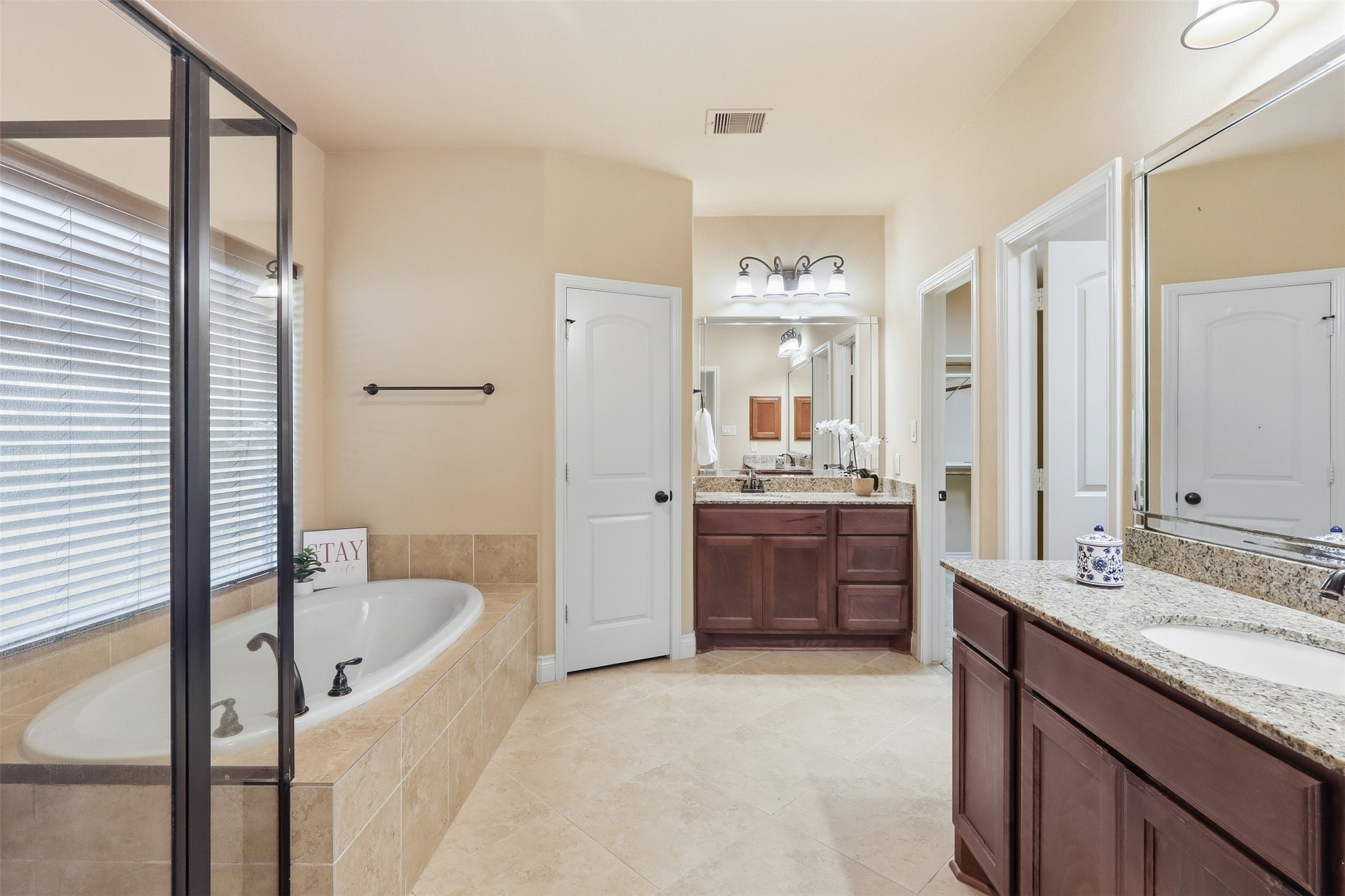 4130 Clover Ridge Lane Sugar Land, TX 77479 - Photo 20 of 48 The primary bathroom features a luxurious soaking tub, a glass-enclosed shower, dual granite-topped vanities and large his and her closets.