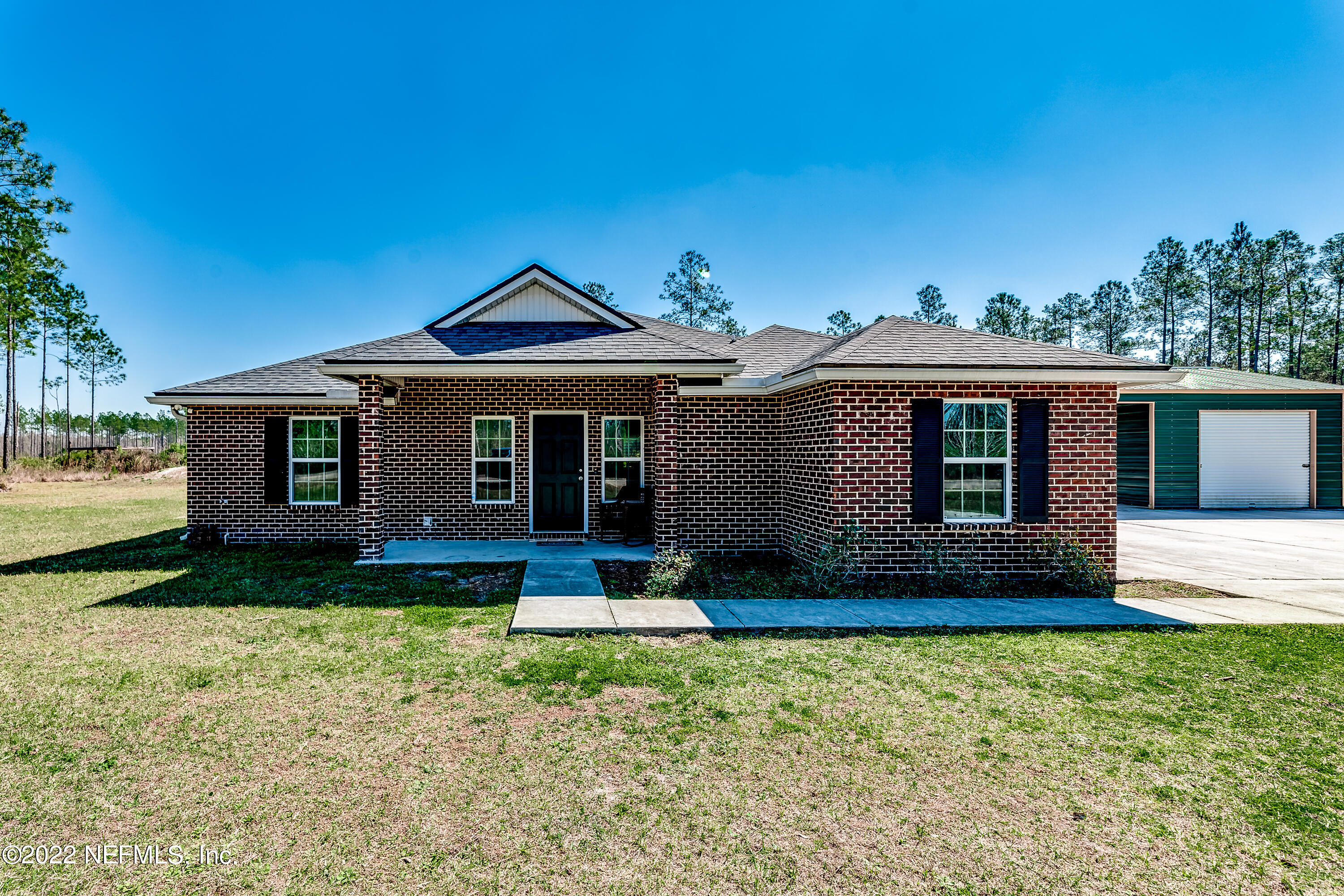 9143 McClelland Road Jacksonville, FL 32234 - Photo 1 of 37 a front view of a house with garden