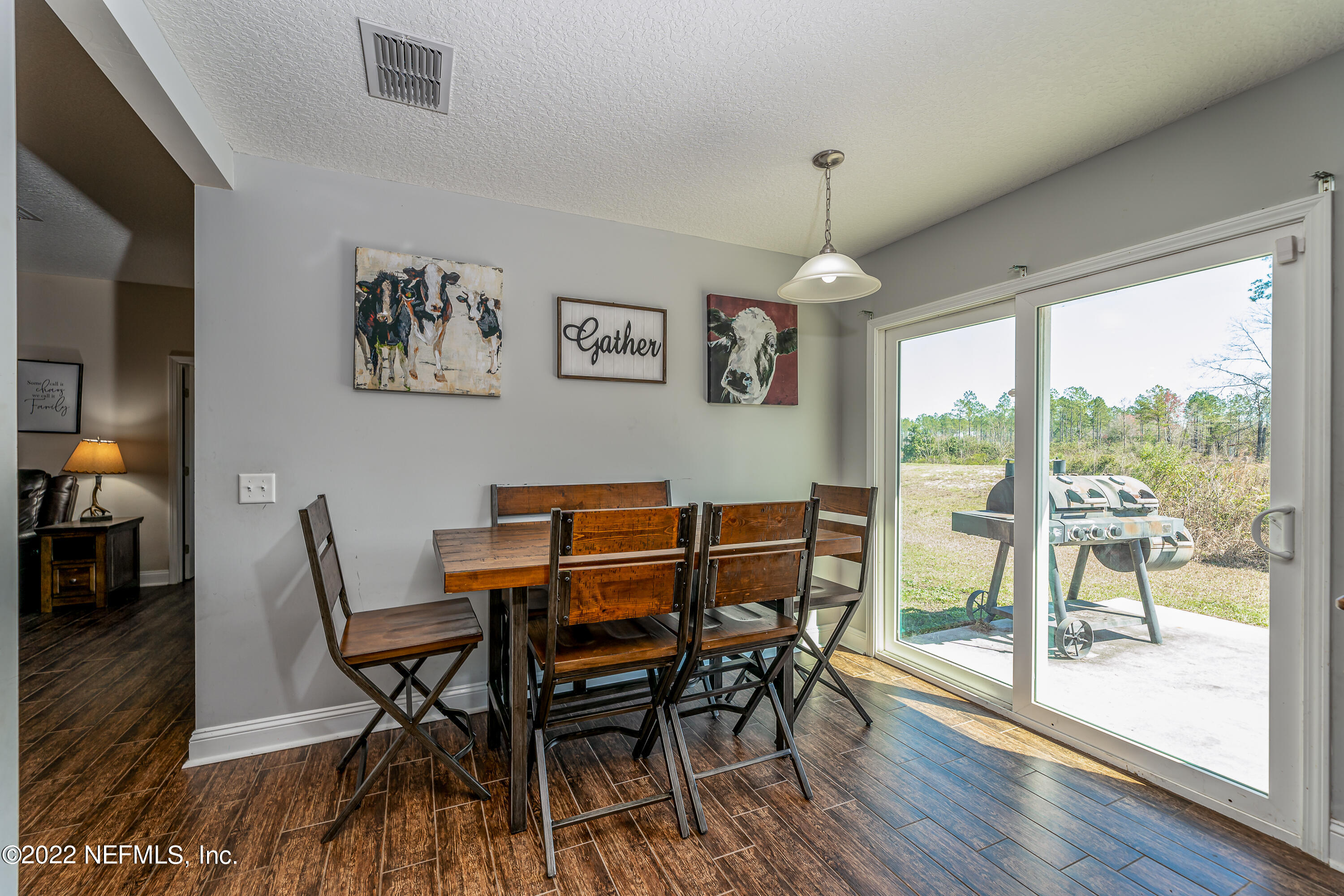 9143 McClelland Road Jacksonville, FL 32234 - Photo 13 of 37 a view of a dining room with furniture window and wooden floor