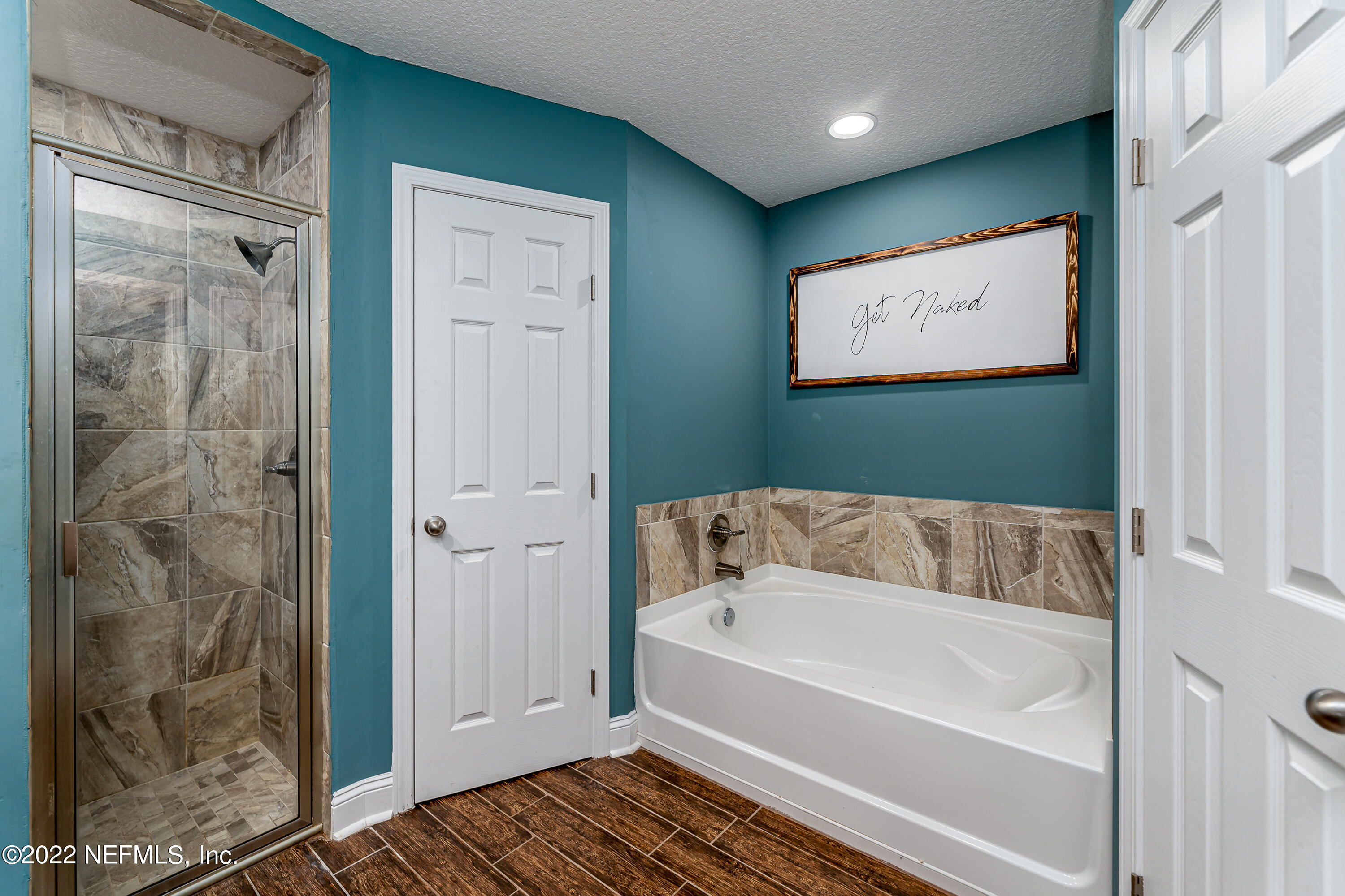 9143 McClelland Road Jacksonville, FL 32234 - Photo 18 of 37 a bathroom with a bathtub and shower