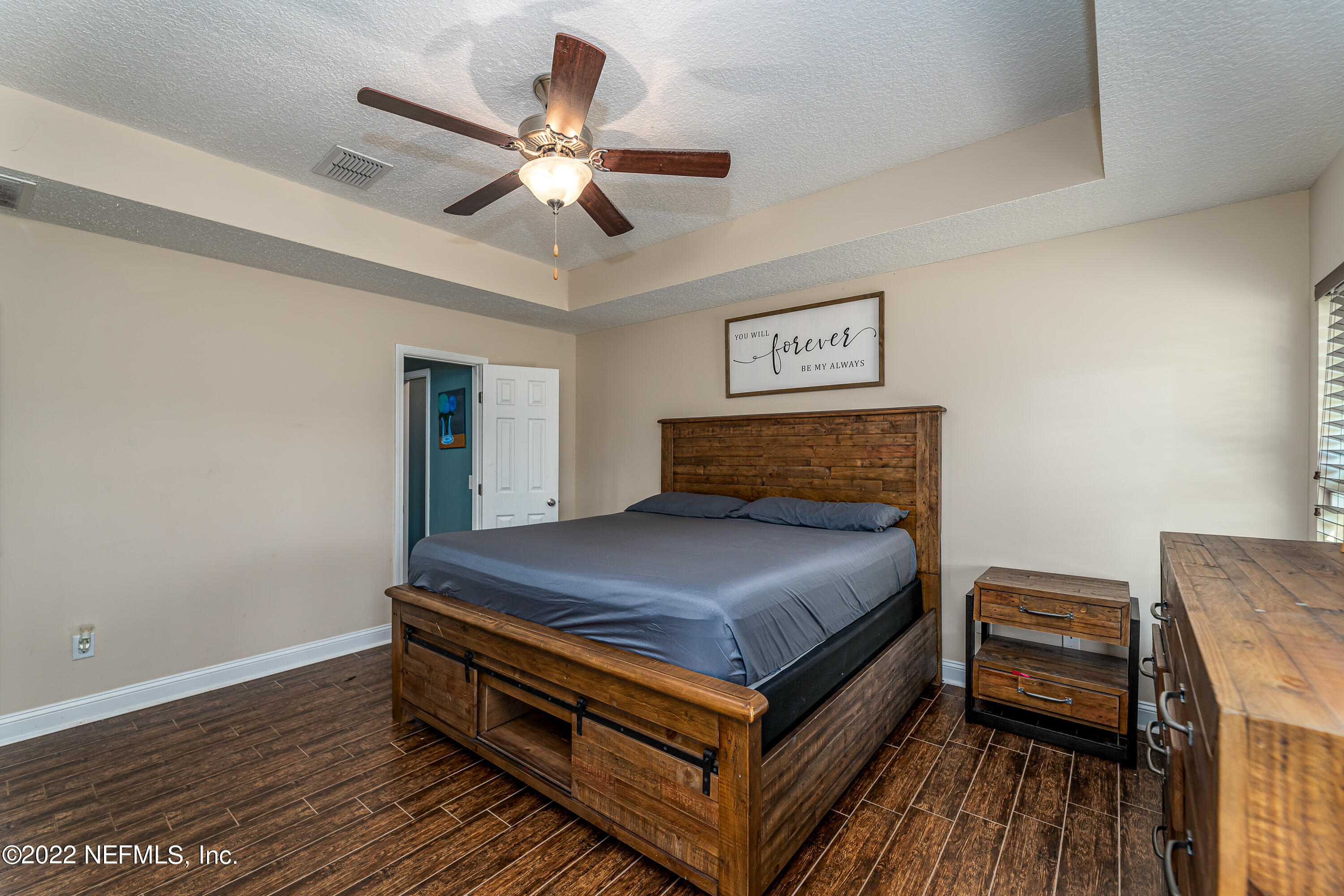 9143 McClelland Road Jacksonville, FL 32234 - Photo 19 of 37 a bedroom with a bed and a ceiling fan