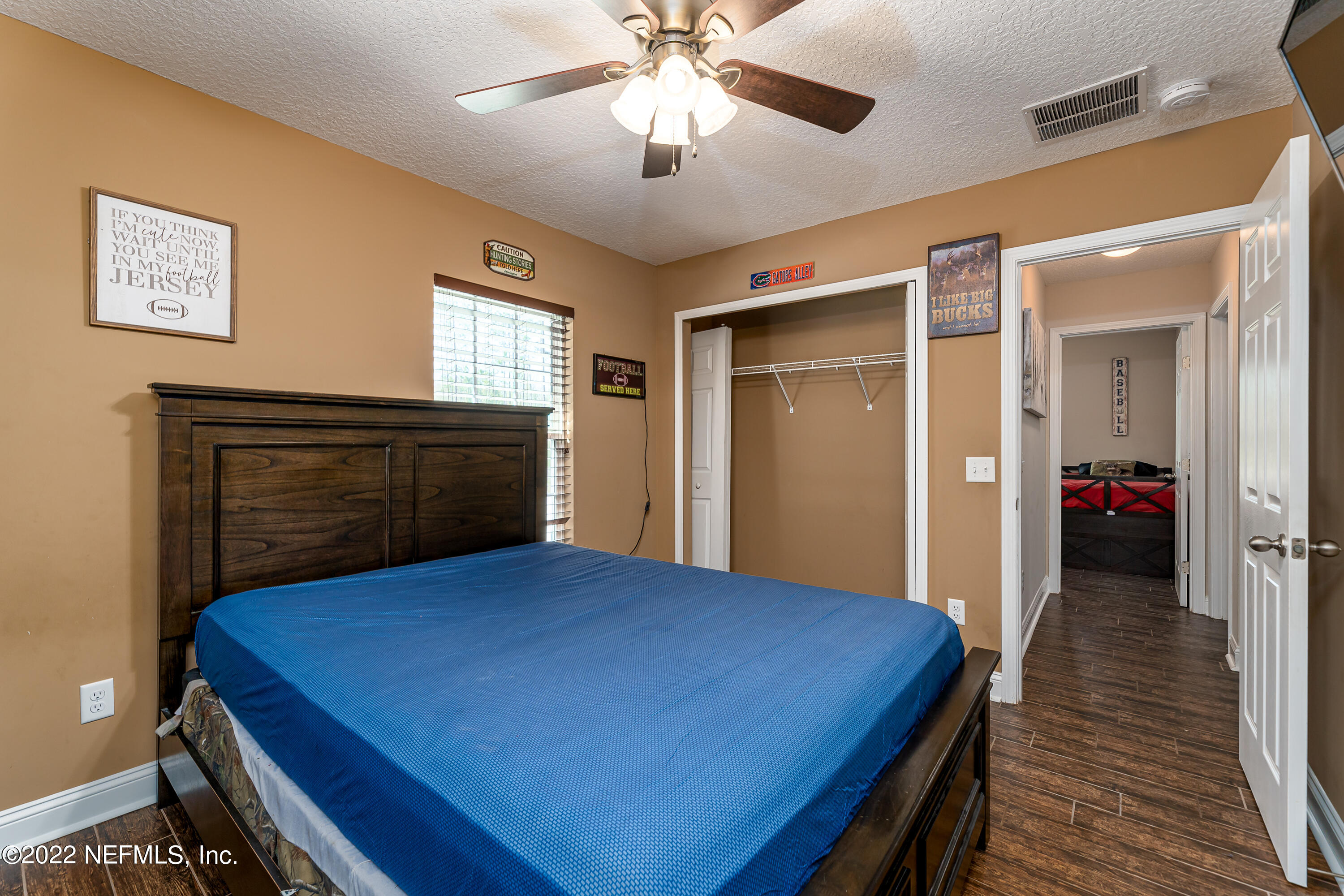 9143 McClelland Road Jacksonville, FL 32234 - Photo 22 of 37 a bed room with a bed and a chandelier