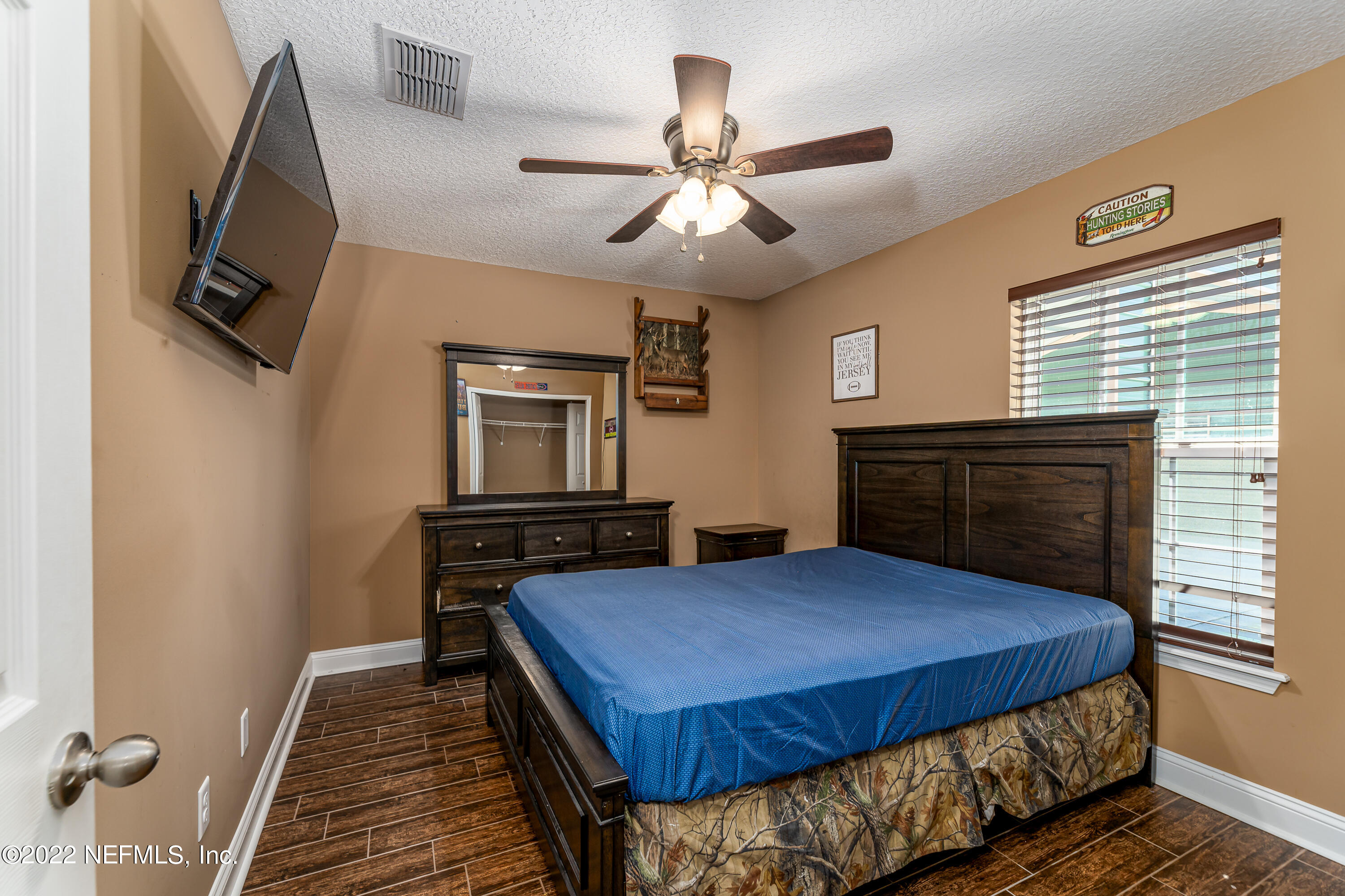 9143 McClelland Road Jacksonville, FL 32234 - Photo 23 of 37 a bedroom with a bed and wooden floor