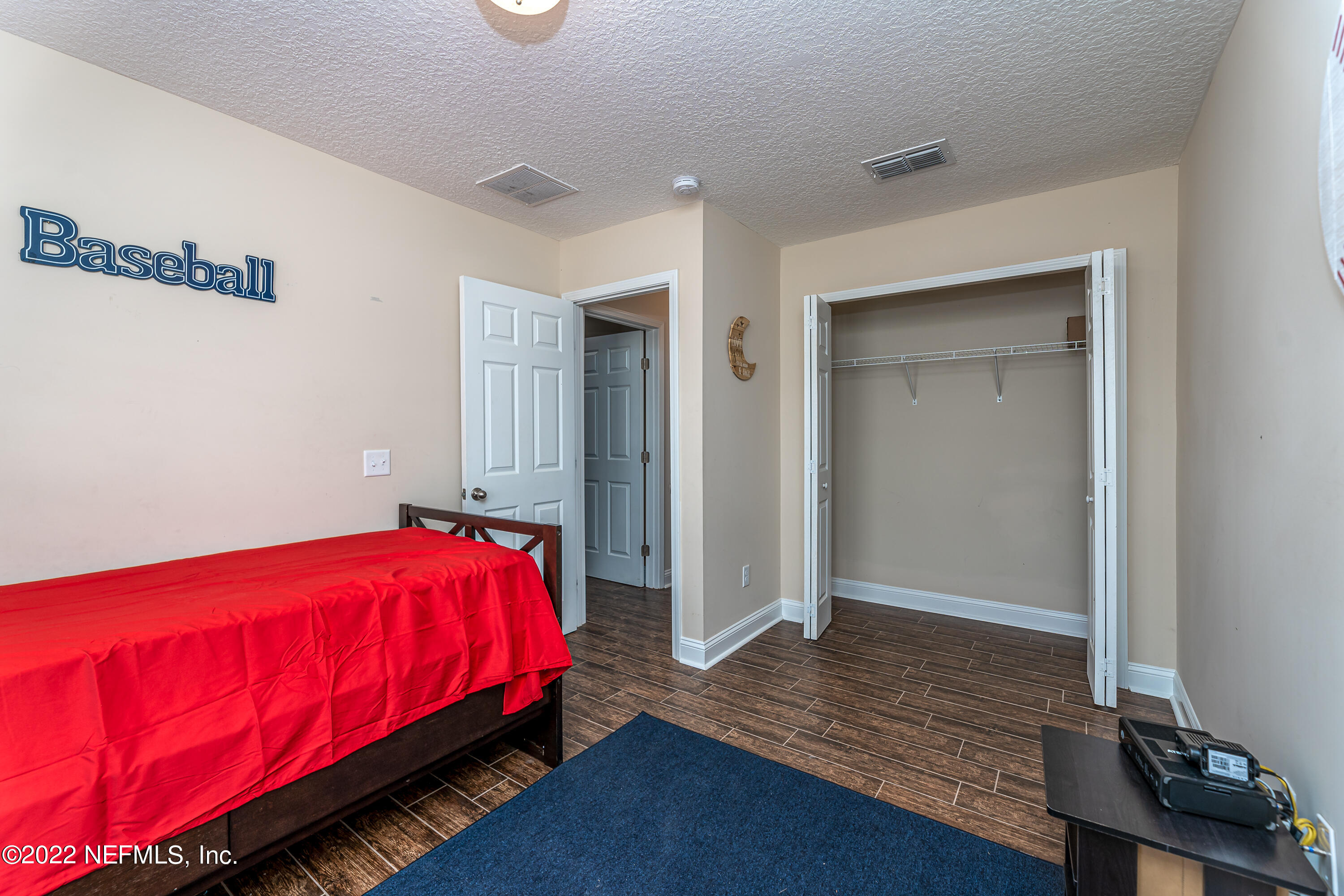9143 McClelland Road Jacksonville, FL 32234 - Photo 24 of 37 a bed sitting in a bedroom next to a window
