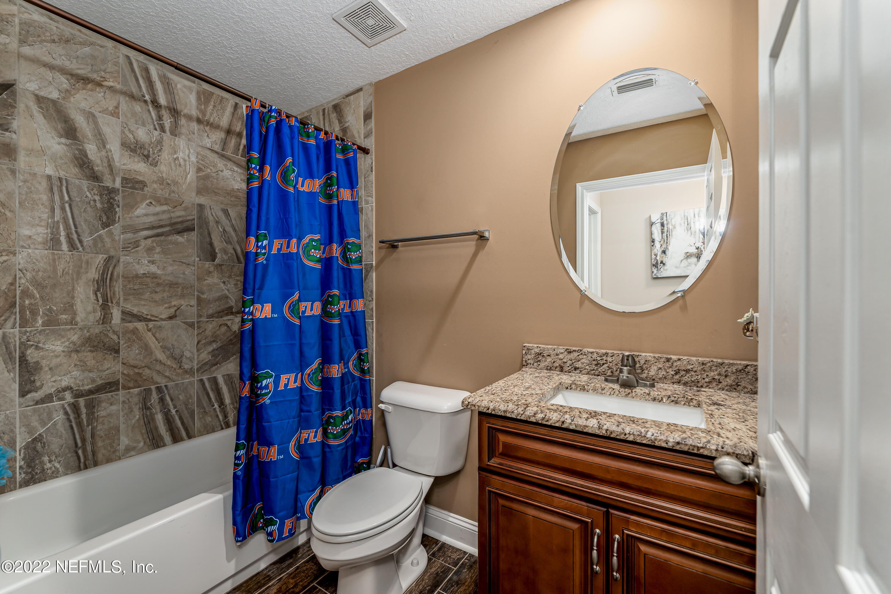 9143 McClelland Road Jacksonville, FL 32234 - Photo 26 of 37 a bathroom with a toilet a sink and a mirror