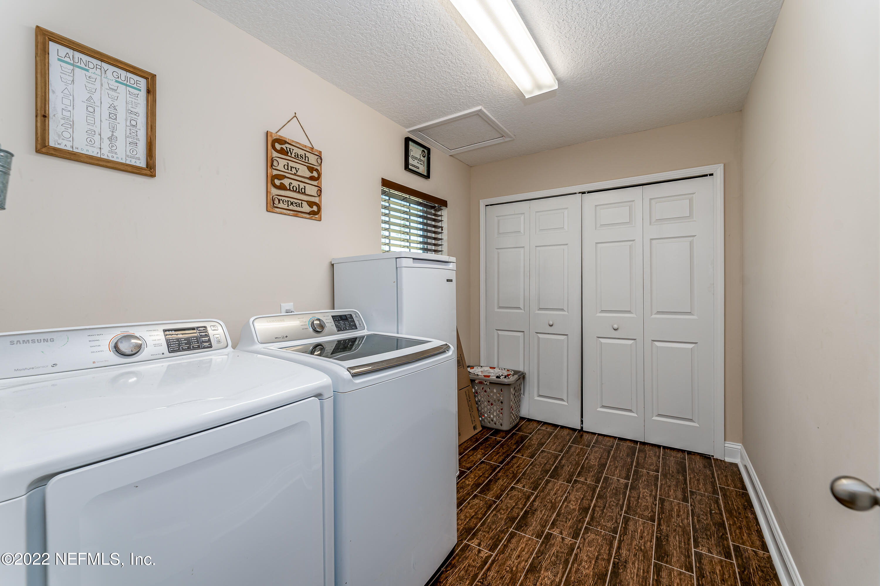 9143 McClelland Road Jacksonville, FL 32234 - Photo 27 of 37 a view of washer and dryer with wooden floor