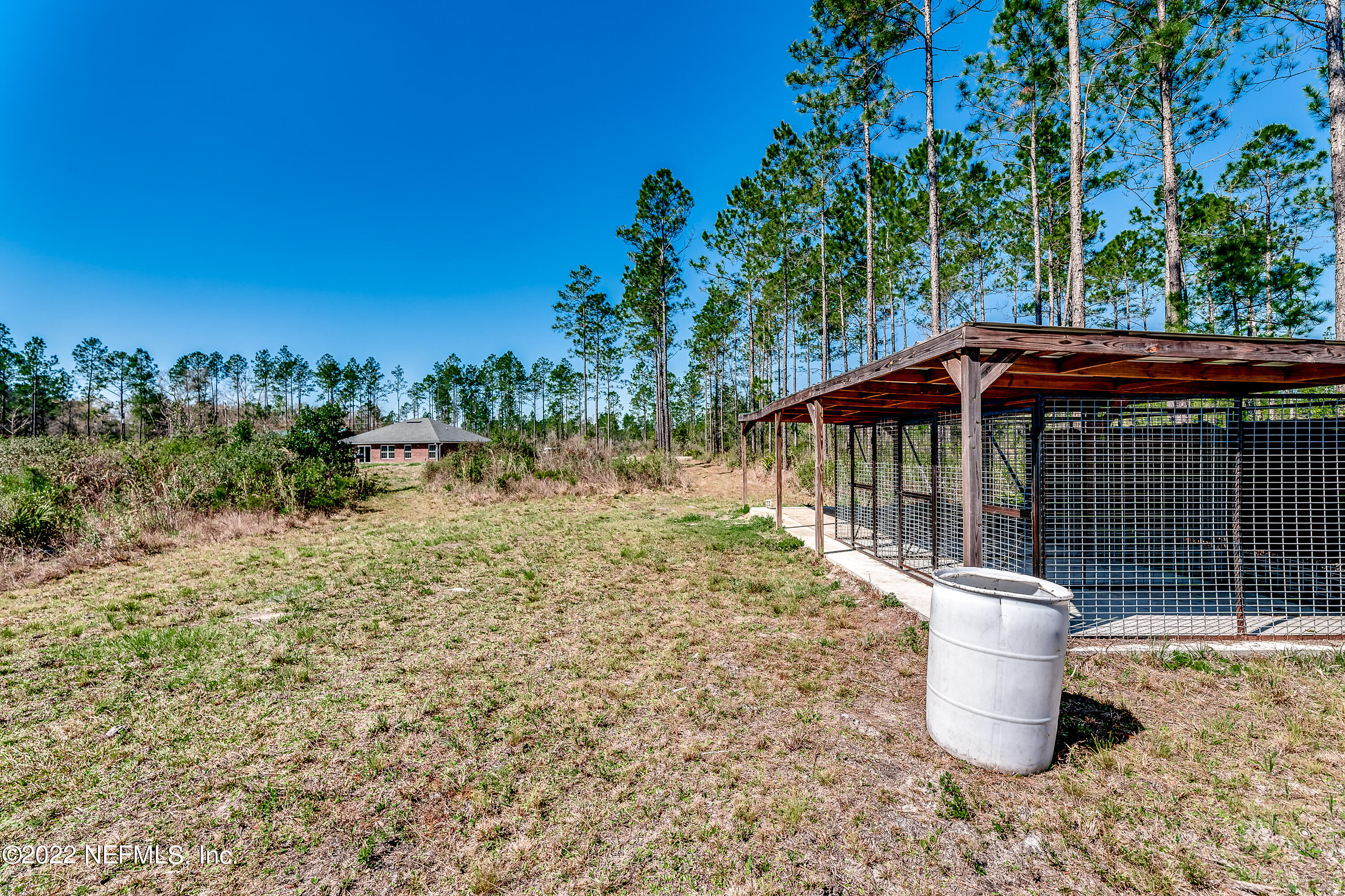 9143 McClelland Road Jacksonville, FL 32234 - Photo 30 of 37 a backyard of a house with table and chairs