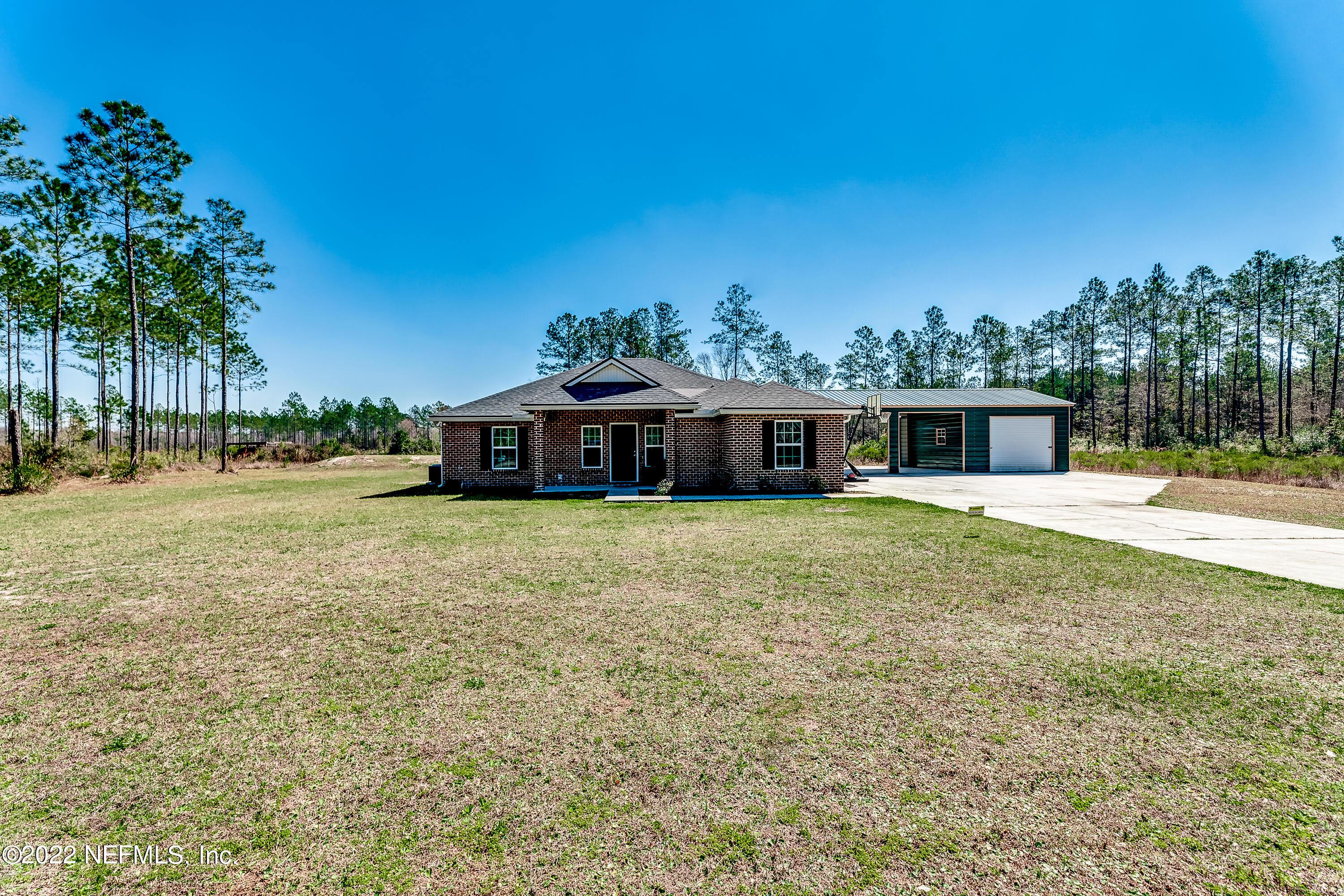 9143 McClelland Road Jacksonville, FL 32234 - Photo 34 of 37 a front view of a house with a yard