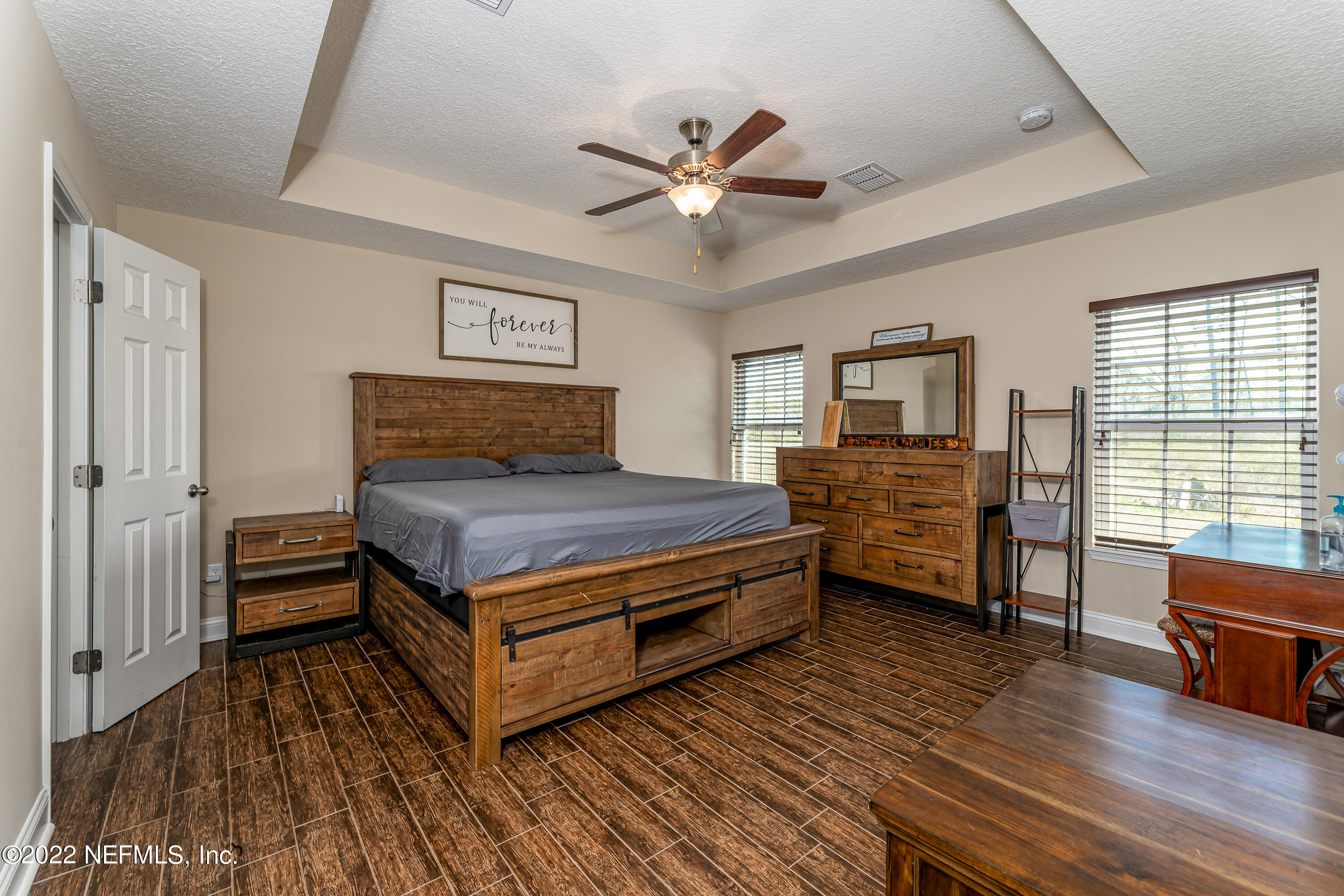 9143 McClelland Road Jacksonville, FL 32234 - Photo 5 of 37 a bedroom with furniture and wooden floor