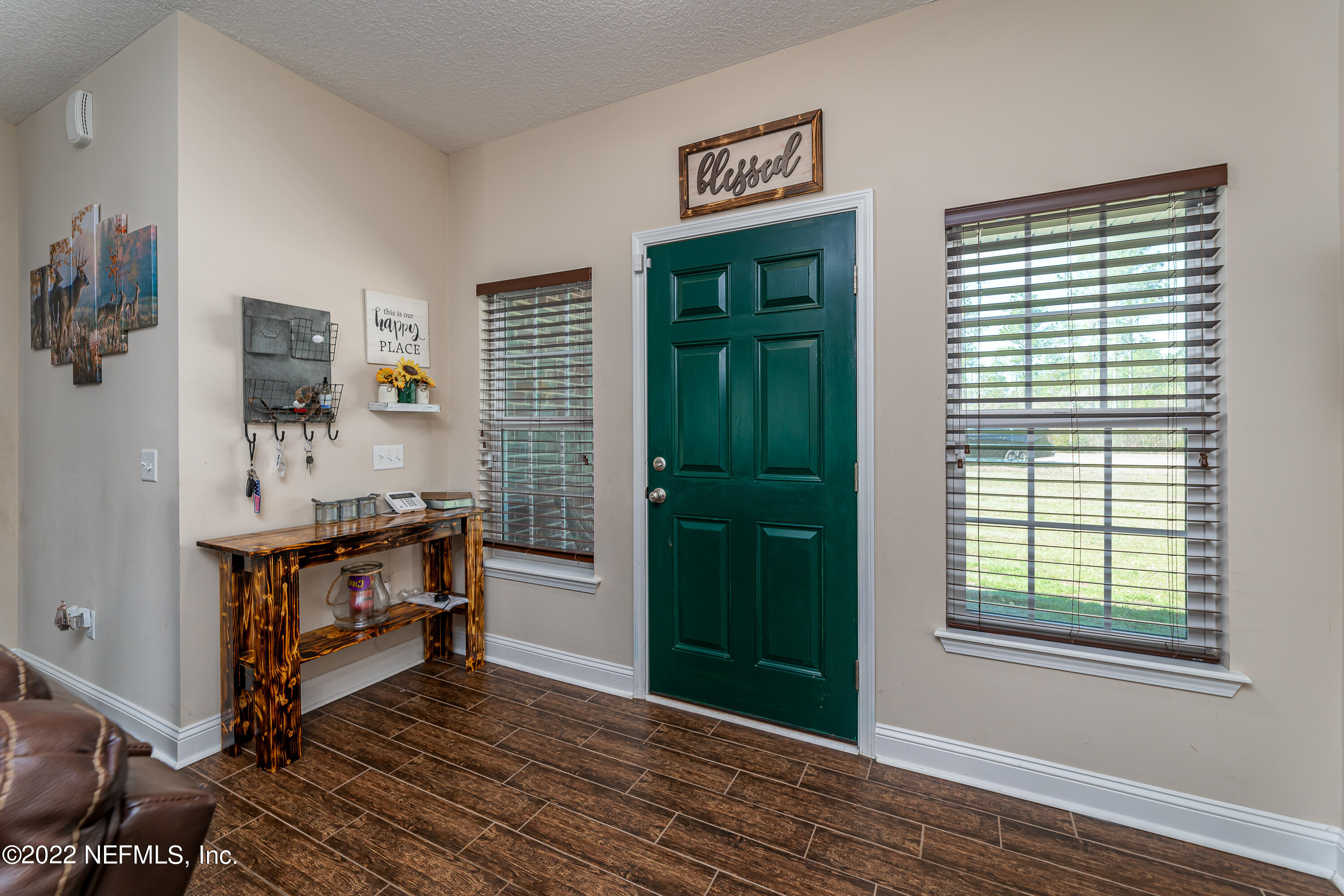 9143 McClelland Road Jacksonville, FL 32234 - Photo 6 of 37 a view of kitchen and hall with wooden floor