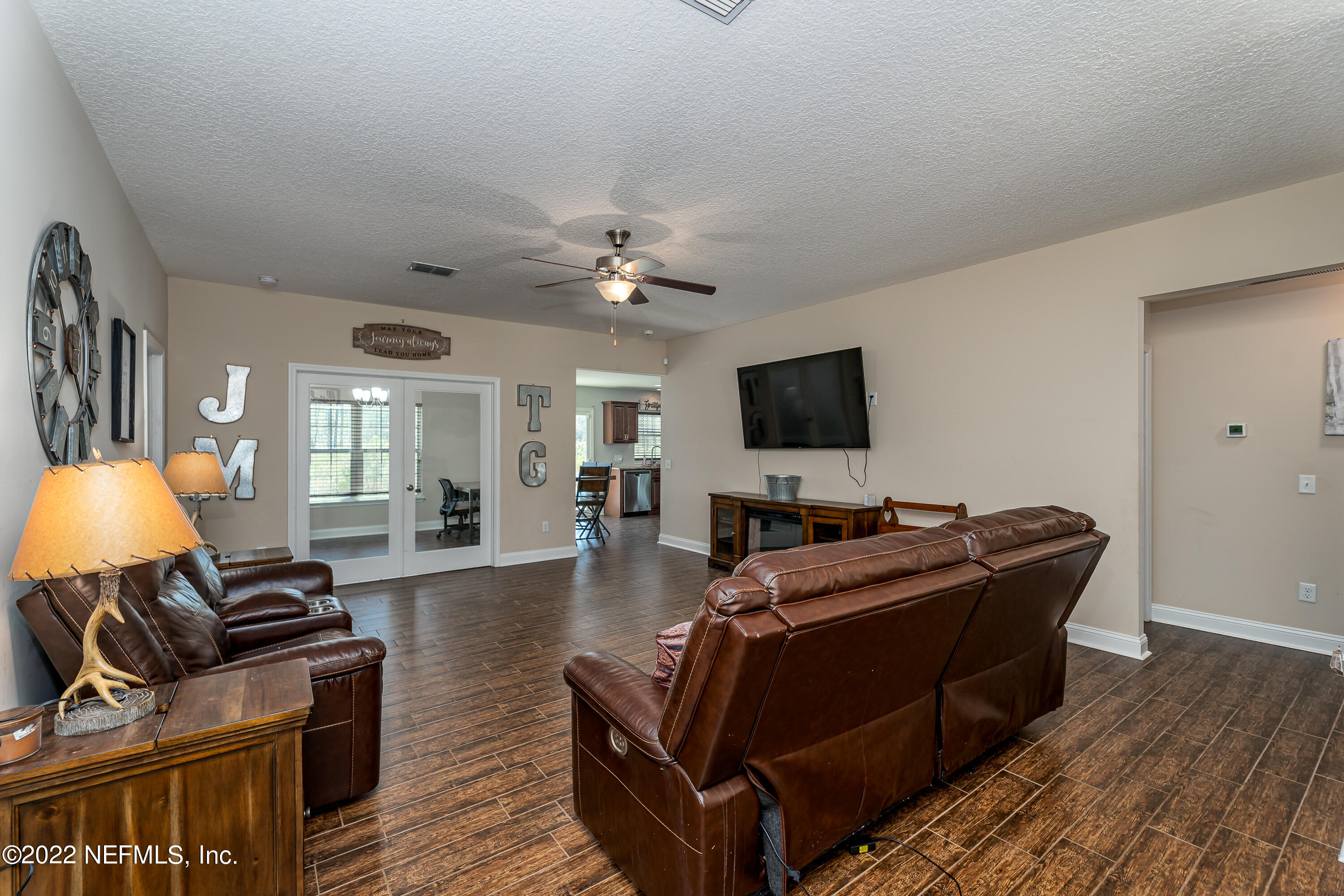 9143 McClelland Road Jacksonville, FL 32234 - Photo 8 of 37 a living room with furniture and a flat screen tv